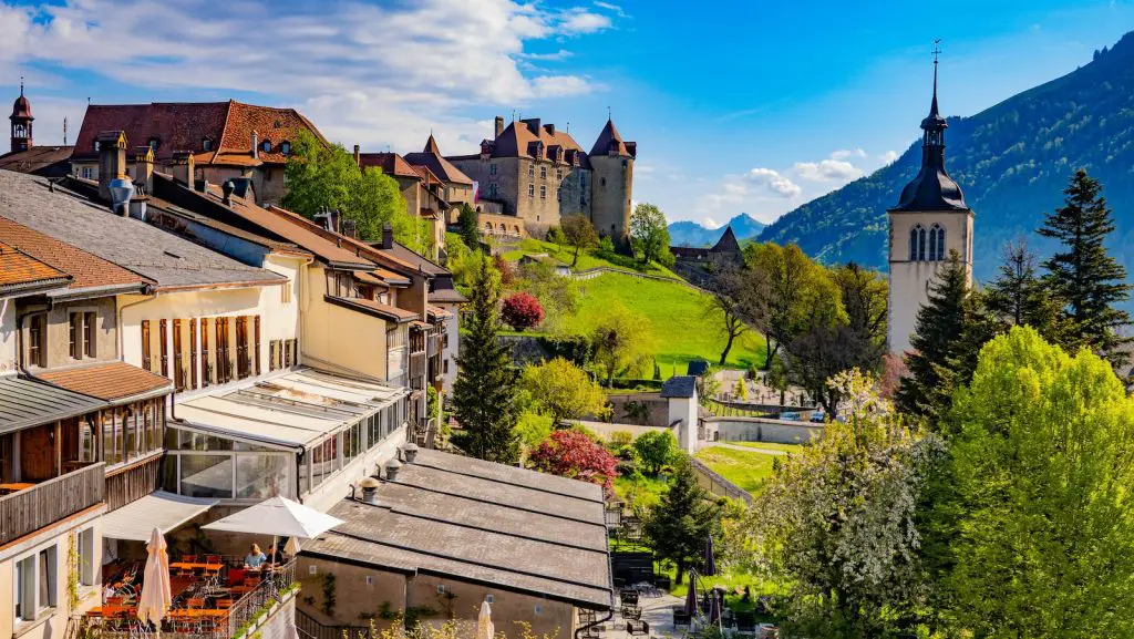 a scenic view of a town with a castle in the background