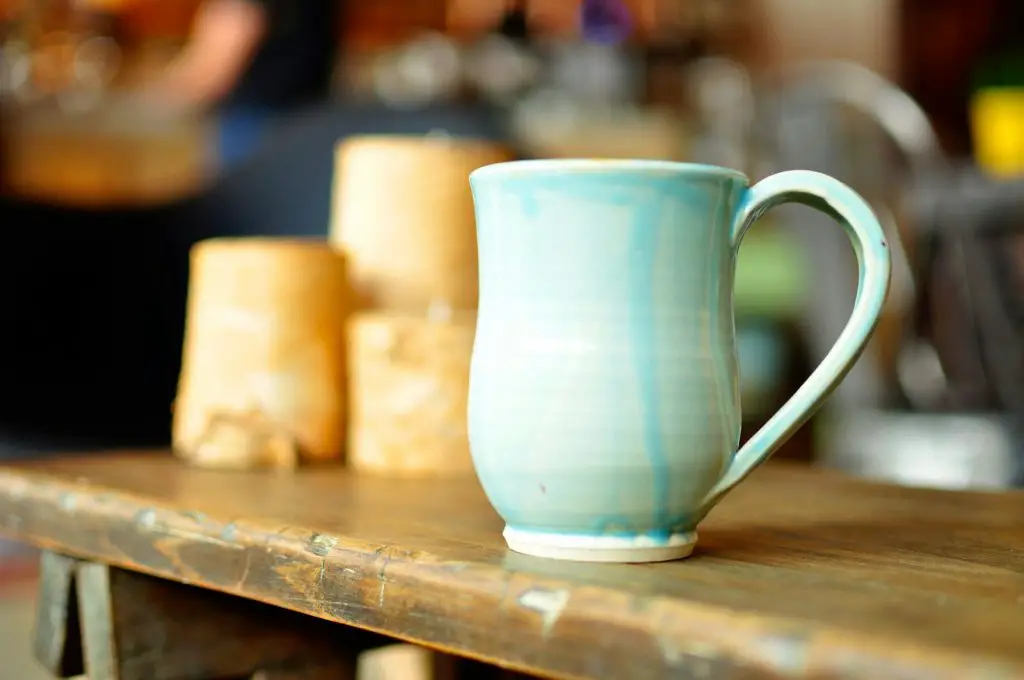 focused photo of a blue ceramic mug